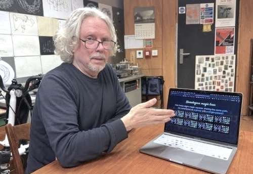 The artist with a laptop, explaining his work