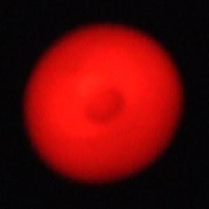 a circular red magnified standby light