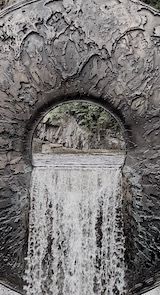 Photograph of an eye-like sculpture and water